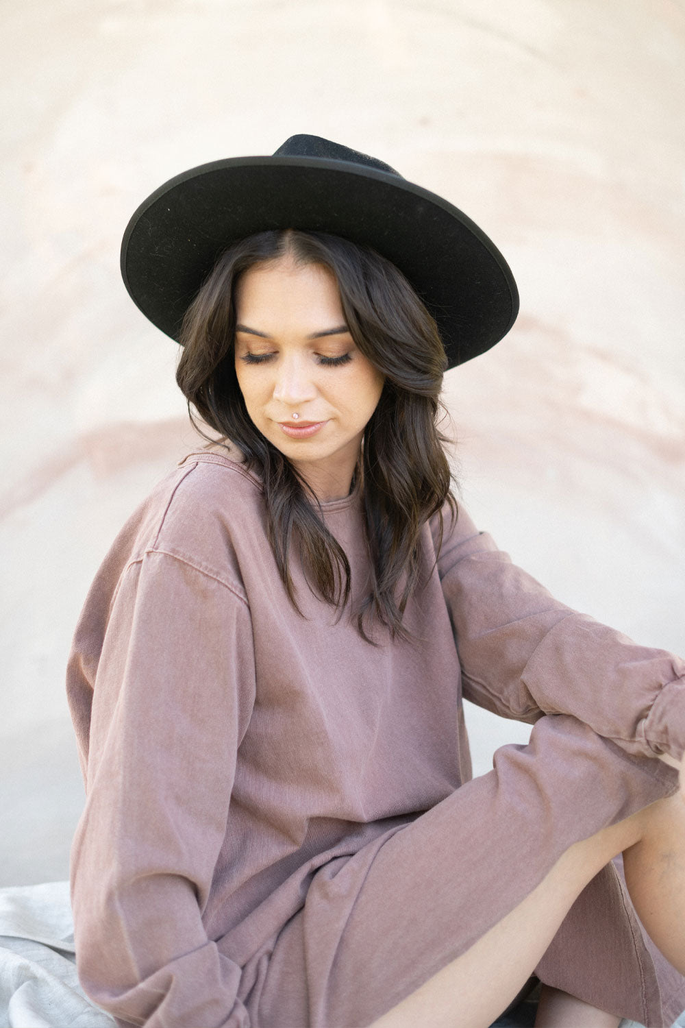 The Taylor Dress in four colors: Brown, Denim, Washed Black, and Peach, featuring long sleeves, a crew neck, and a slight hem slit.