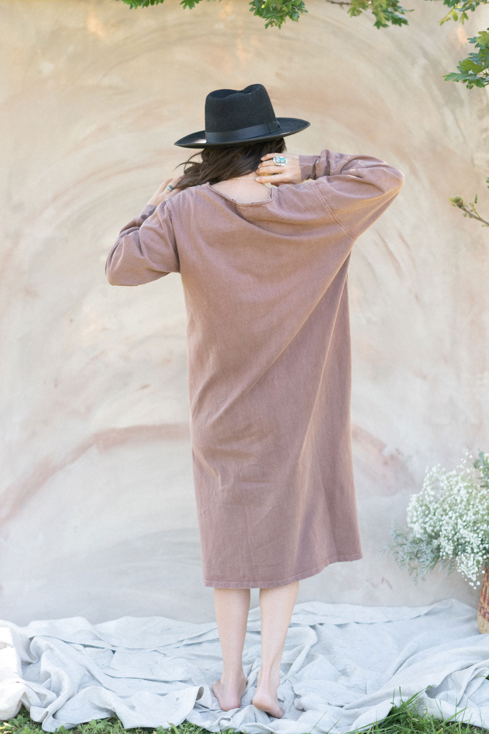 The Taylor Dress in four colors: Brown, Denim, Washed Black, and Peach, featuring long sleeves, a crew neck, and a slight hem slit.