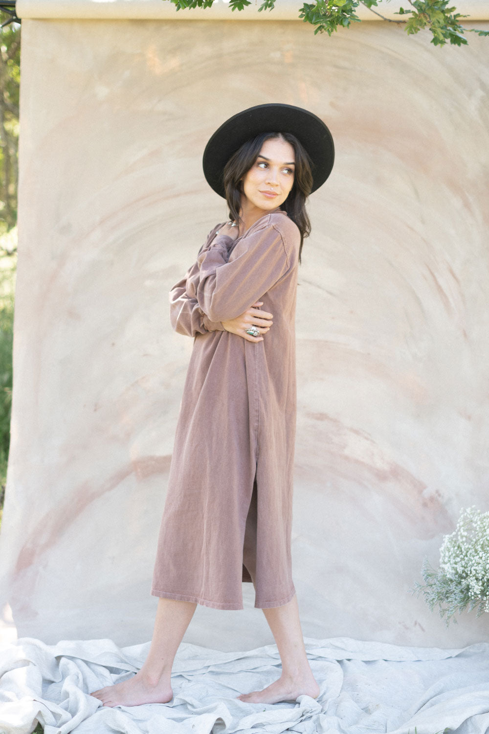 The Taylor Dress in four colors: Brown, Denim, Washed Black, and Peach, featuring long sleeves, a crew neck, and a slight hem slit.