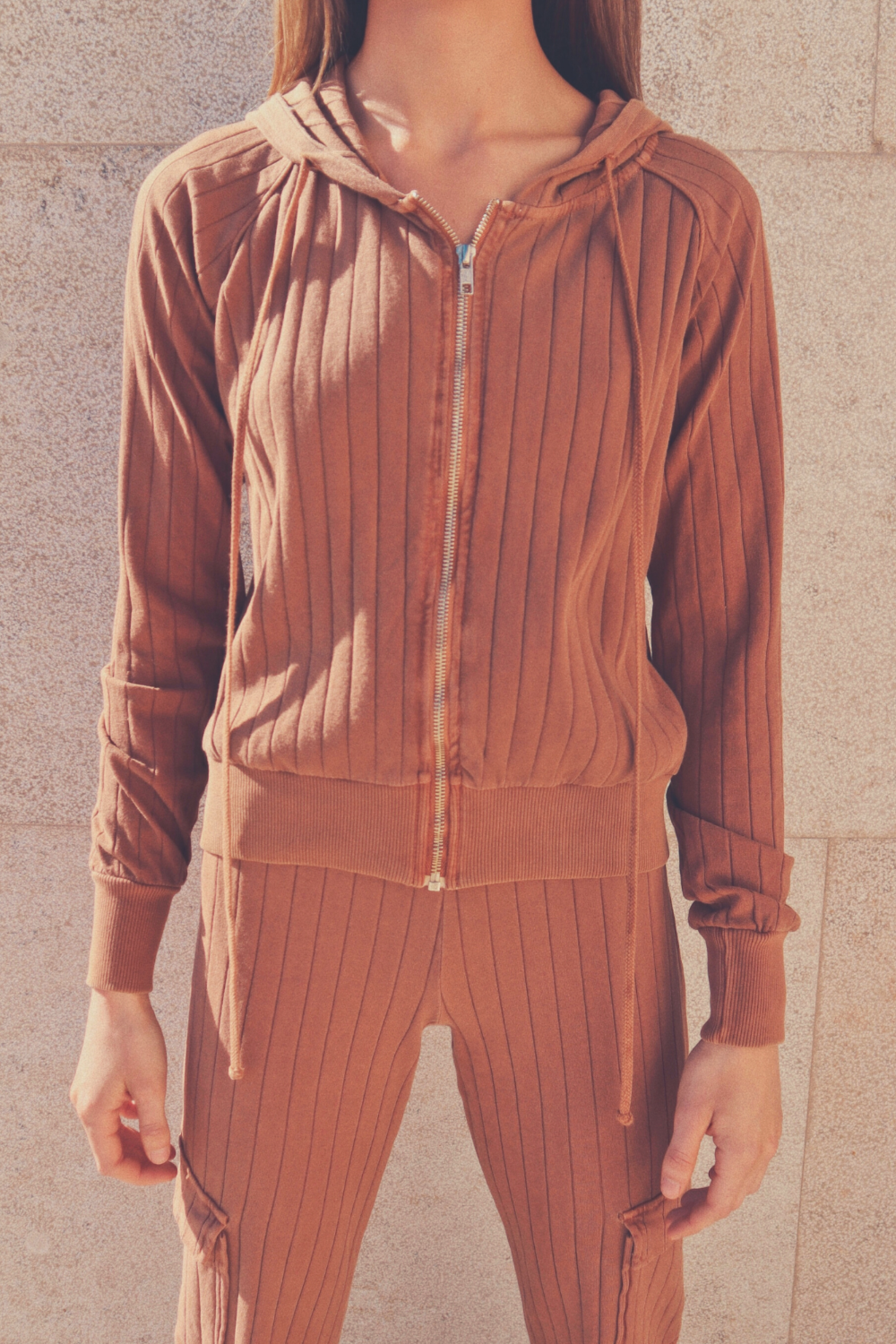 The Traveler Set featuring a stylish zip-up hoodie and ribbed pants in Saddle and Oatmeal colors, made from 100% organic cotton.