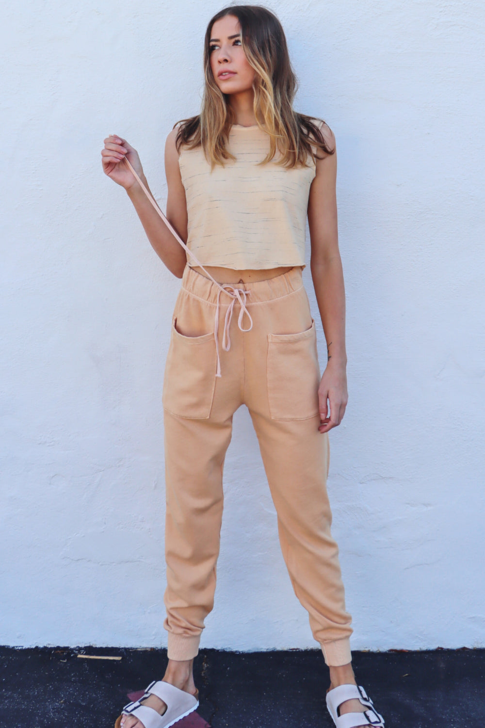 Woman in casual beige outfit.