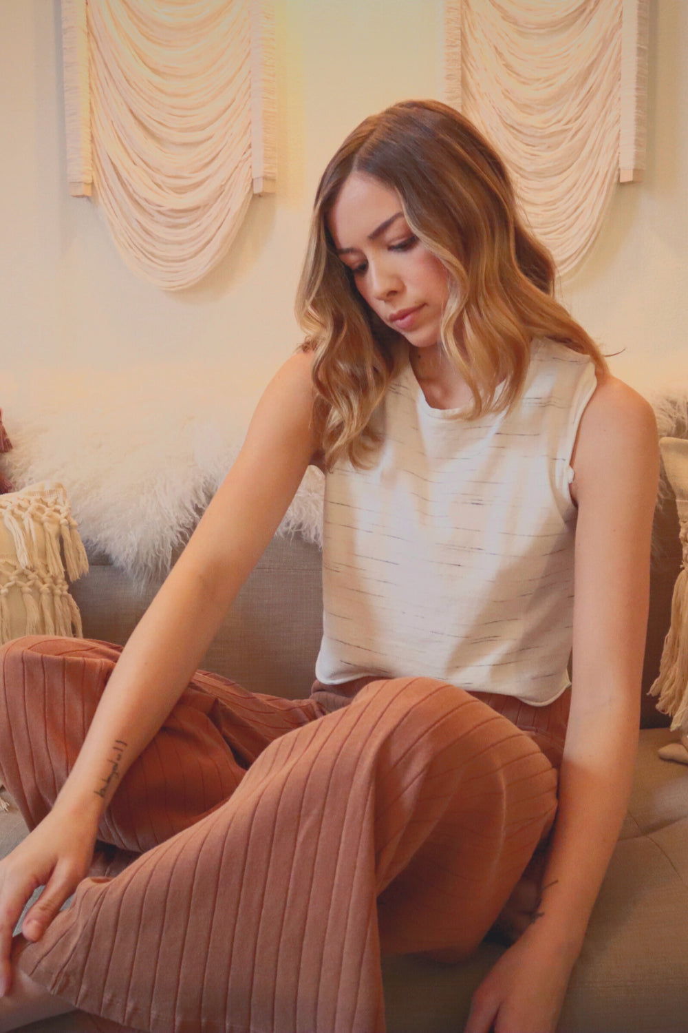 Woman sitting in cozy room.