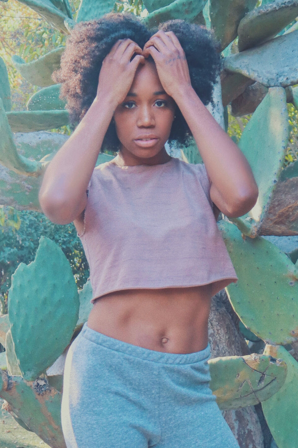 Woman posing in front of cactus