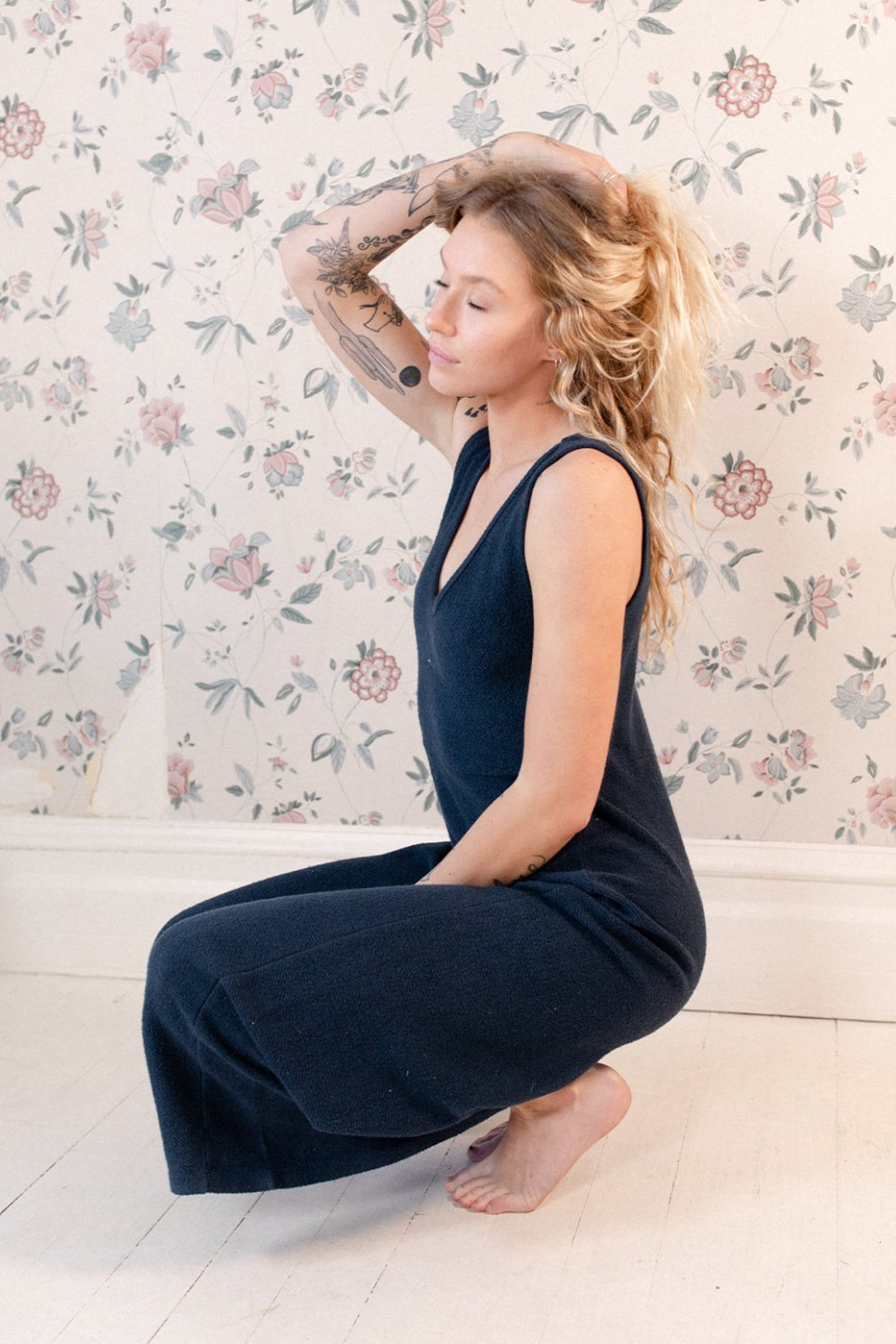 The Yucca Jumpsuit displayed in Navy color, featuring thick tank top straps, wide leg design, and scoop neckline, perfect for versatile styling.