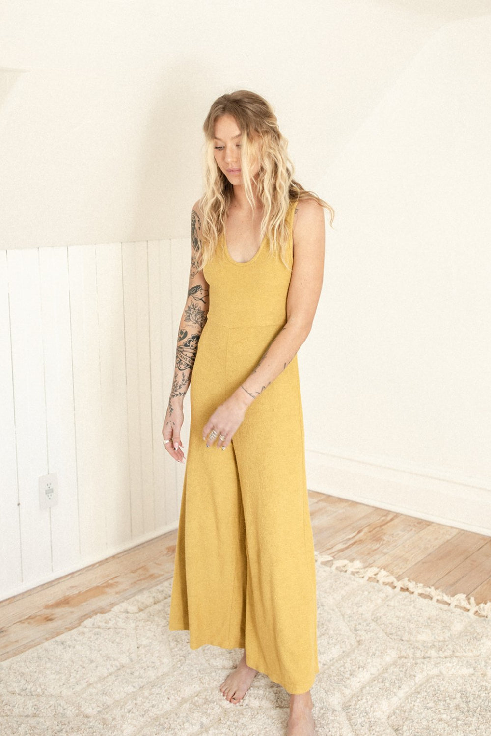 The Yucca Jumpsuit displayed in Navy color, featuring thick tank top straps, wide leg design, and scoop neckline, perfect for versatile styling.