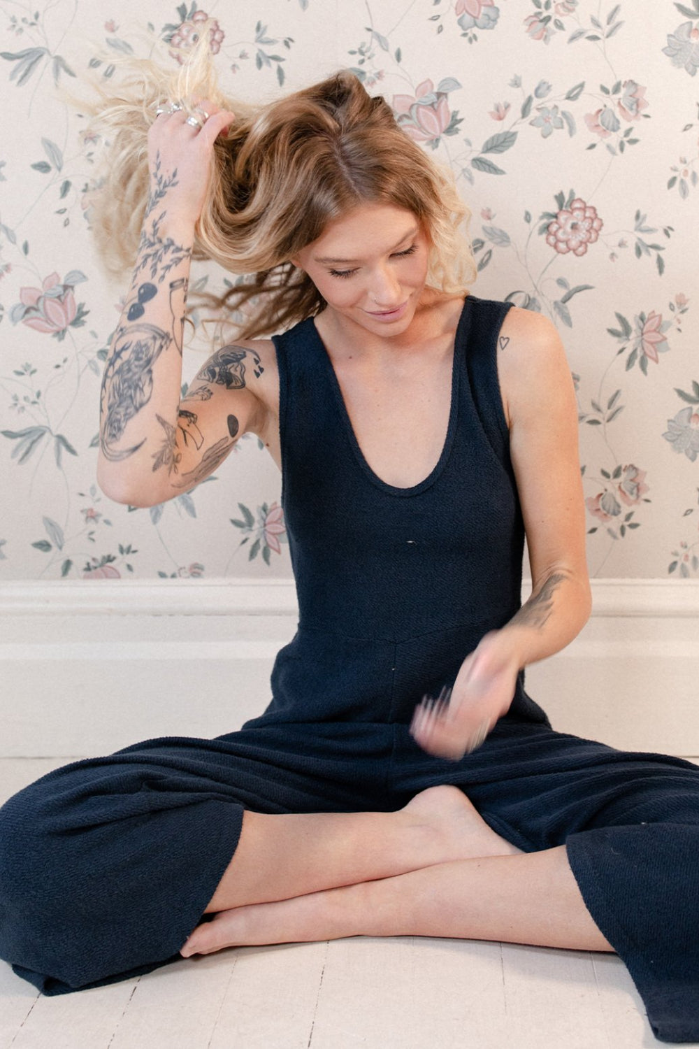 The Yucca Jumpsuit displayed in Navy color, featuring thick tank top straps, wide leg design, and scoop neckline, perfect for versatile styling.