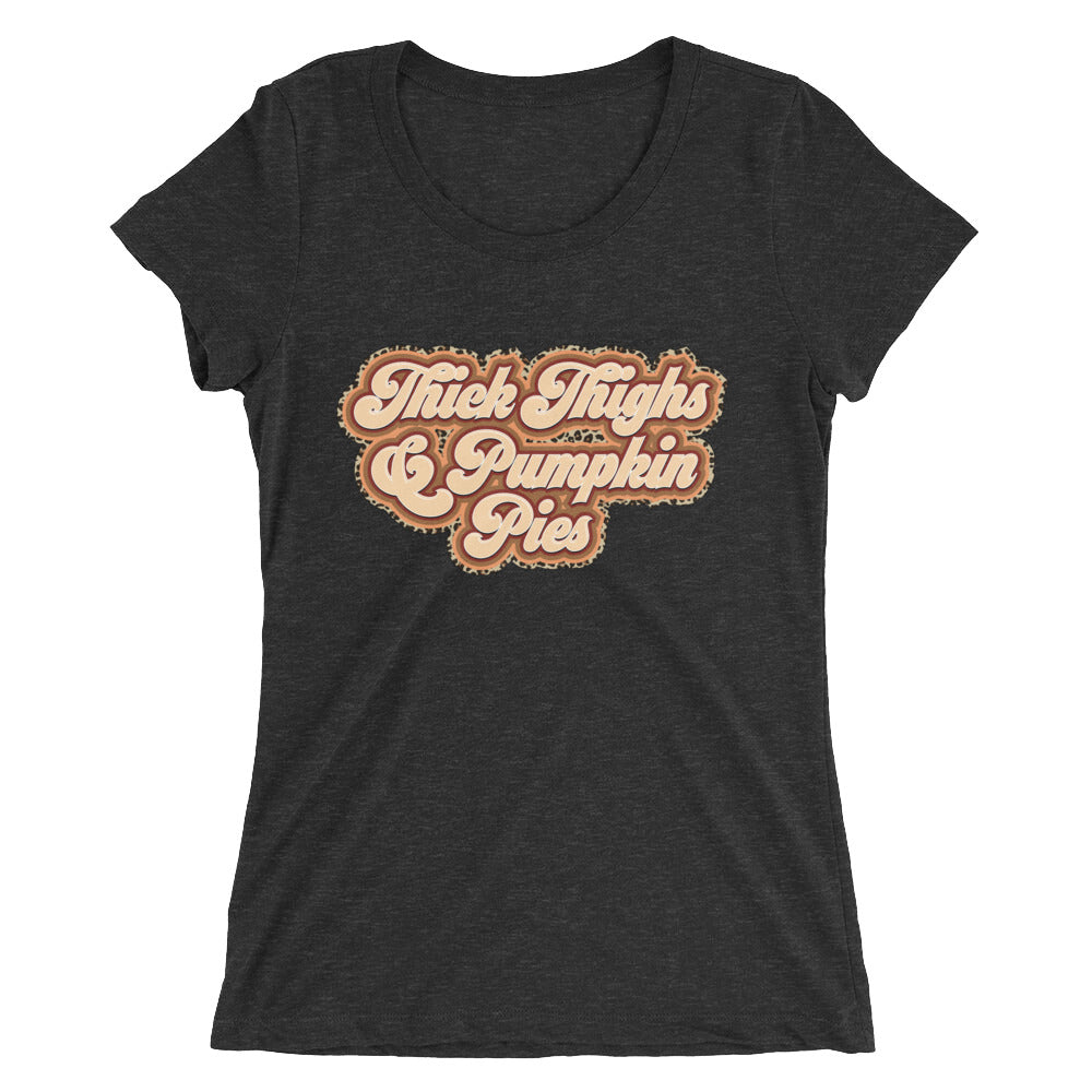 A stylish women's fitted tee featuring the graphic 'Thick Thighs & Pumpkin Pies' in a vibrant color, showcasing its soft fabric and modern design.