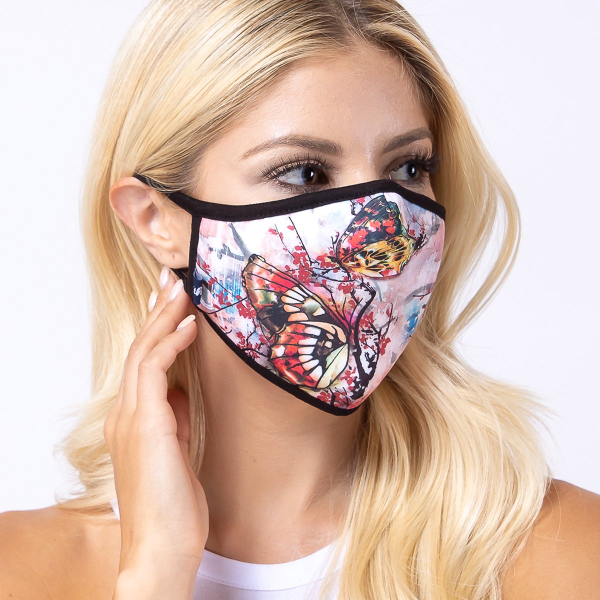 A colorful tie dye butterfly face mask with a 3-layered design, featuring a polyester exterior and cotton interior, suitable for unisex wear.