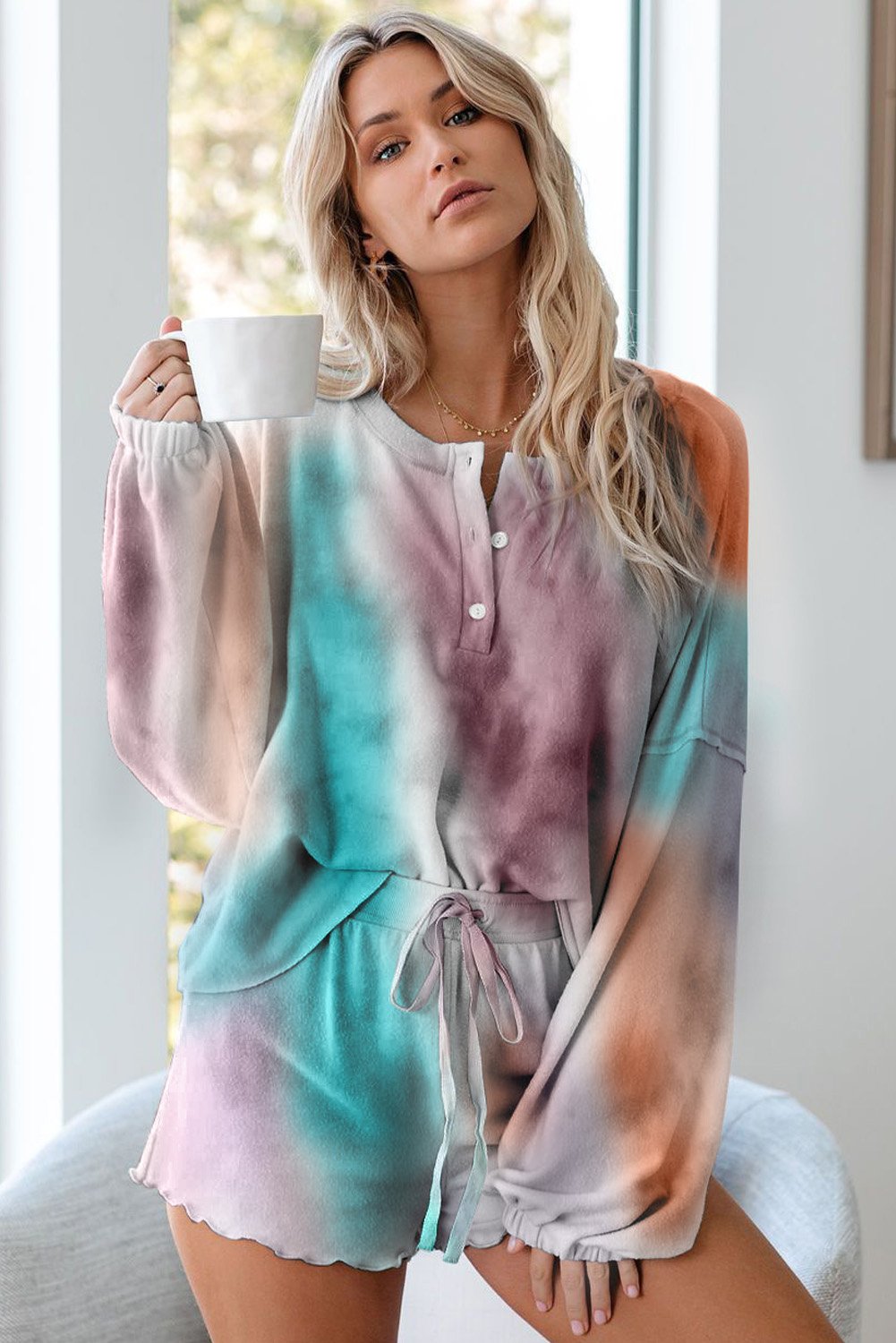 A stylish Tie Dye Knit Pajamas Set featuring a long sleeve pullover and shorts with a chic tie dye pattern, perfect for cozy lounging.