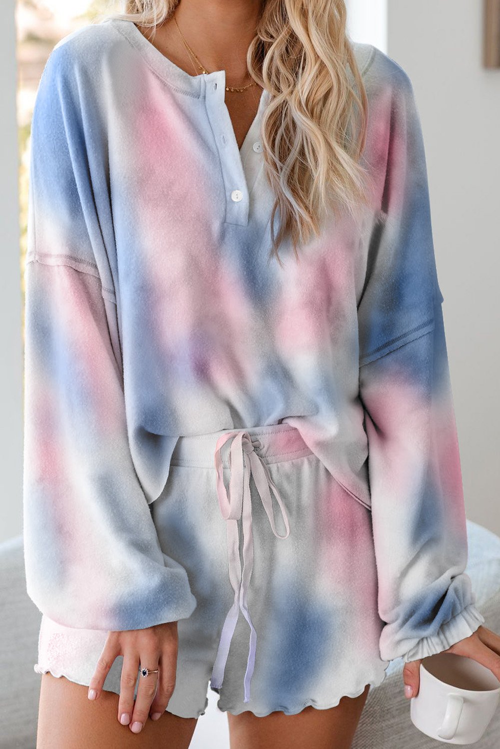 A stylish Tie Dye Knit Pajamas Set featuring a long sleeve pullover and shorts with a chic tie dye pattern, perfect for cozy lounging.