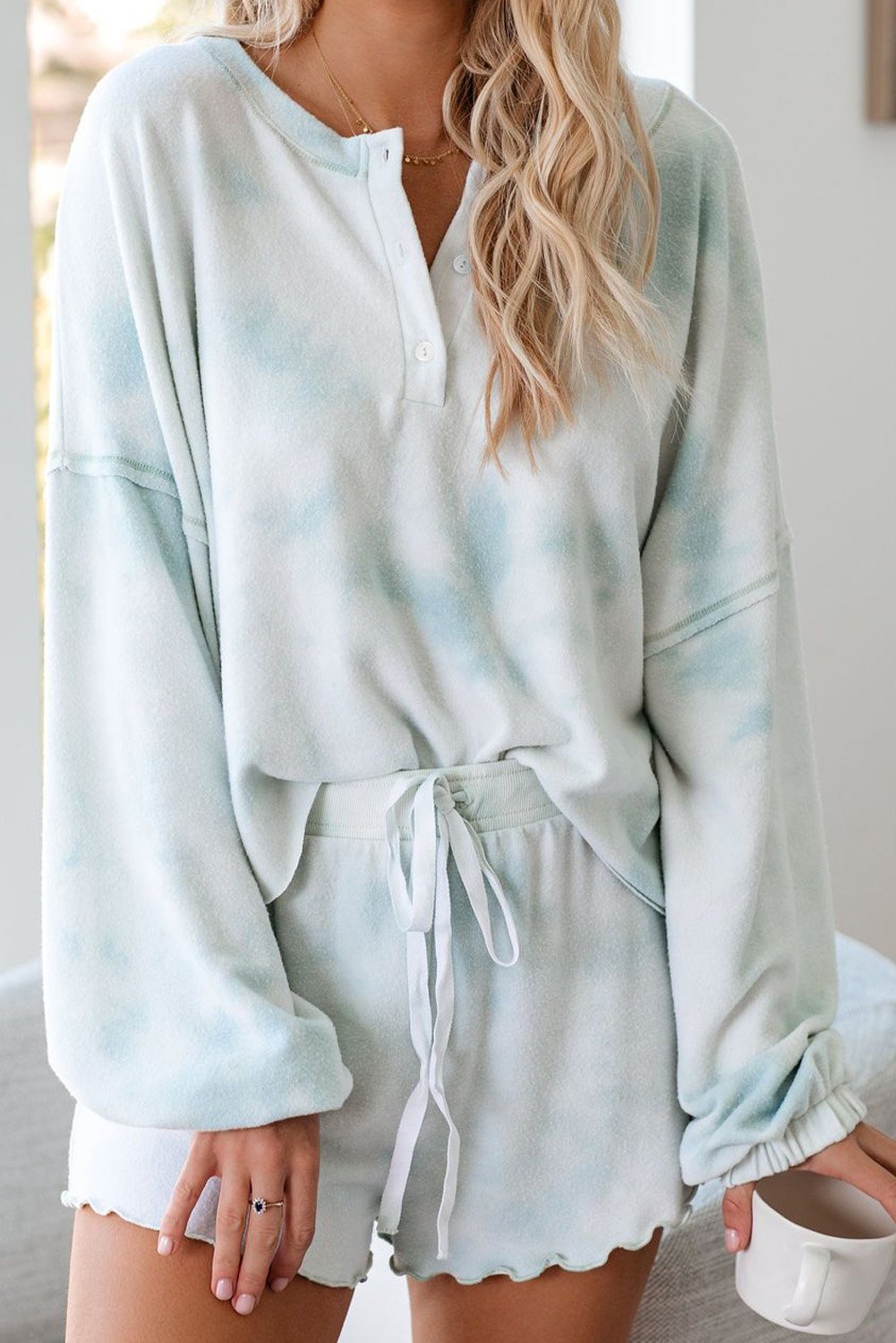 A stylish Tie Dye Knit Pajamas Set featuring a long sleeve pullover and shorts with a chic tie dye pattern, perfect for cozy lounging.