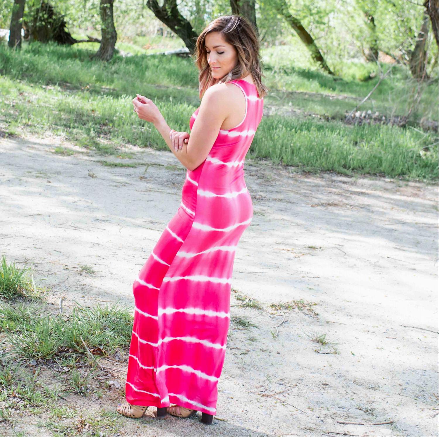 A vibrant tie dye maxi dress featuring ocean-inspired colors, sleeveless design, and a flowing silhouette, perfect for summer outings.