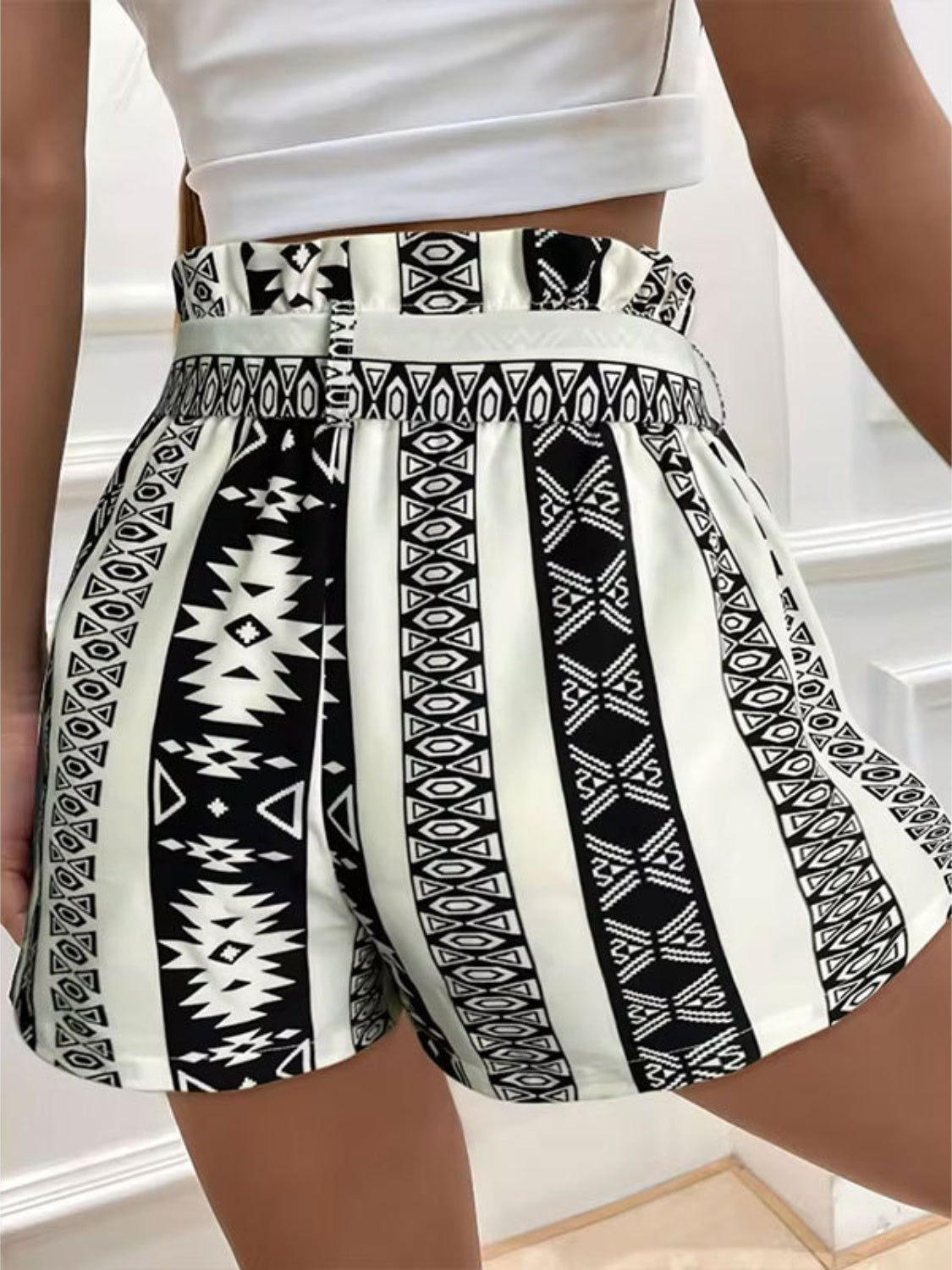 A pair of stylish Tied Geometric Shorts made from 100% polyester, featuring a trendy tied design and available in various sizes.