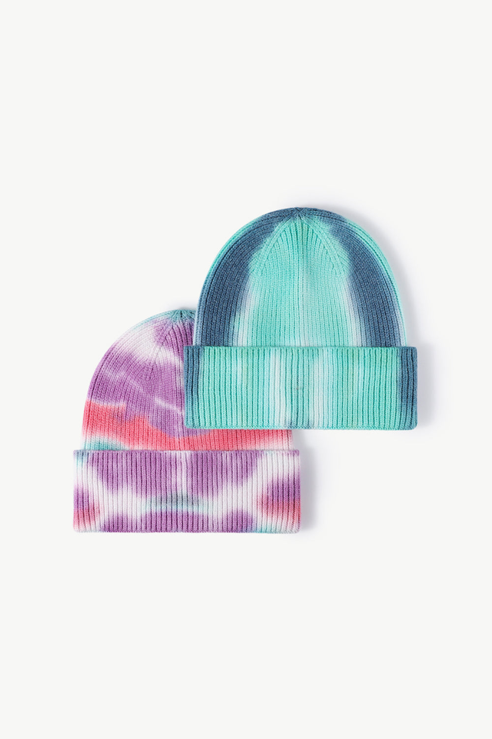 A colorful tie-dye cuffed knit beanie displayed in a flat lay style, showcasing its vibrant patterns and soft texture.