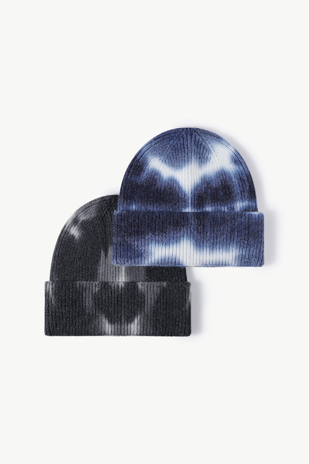 A colorful tie-dye cuffed knit beanie displayed in a flat lay style, showcasing its vibrant patterns and soft texture.