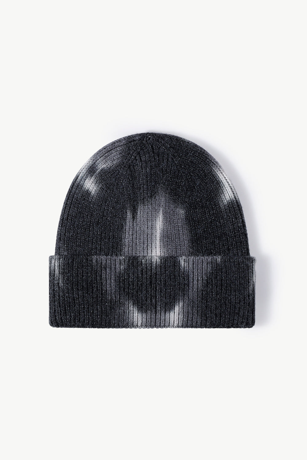 A colorful tie-dye cuffed knit beanie displayed in a flat lay style, showcasing its vibrant patterns and soft texture.