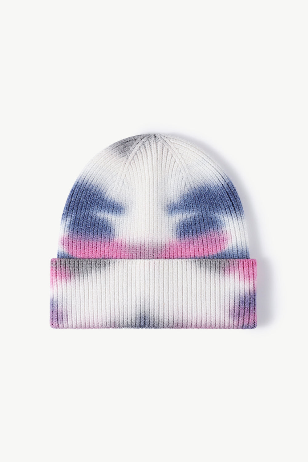 A colorful tie-dye cuffed knit beanie displayed in a flat lay style, showcasing its vibrant patterns and soft texture.