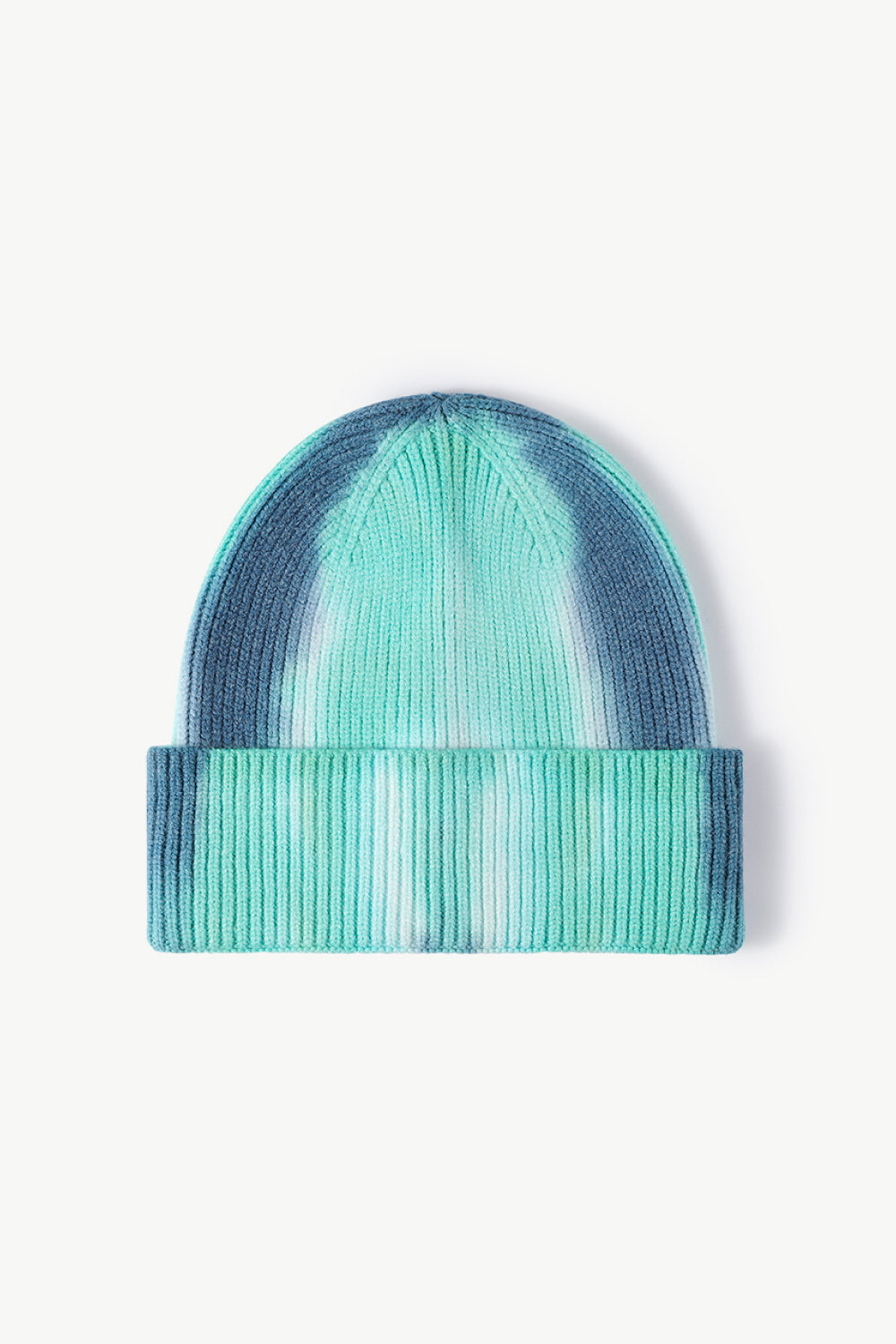 A colorful tie-dye cuffed knit beanie displayed in a flat lay style, showcasing its vibrant patterns and soft texture.