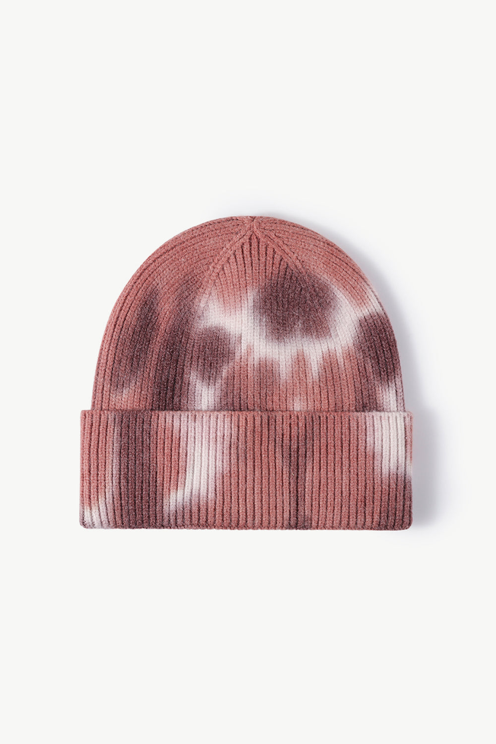 A colorful tie-dye cuffed knit beanie displayed in a flat lay style, showcasing its vibrant patterns and soft texture.