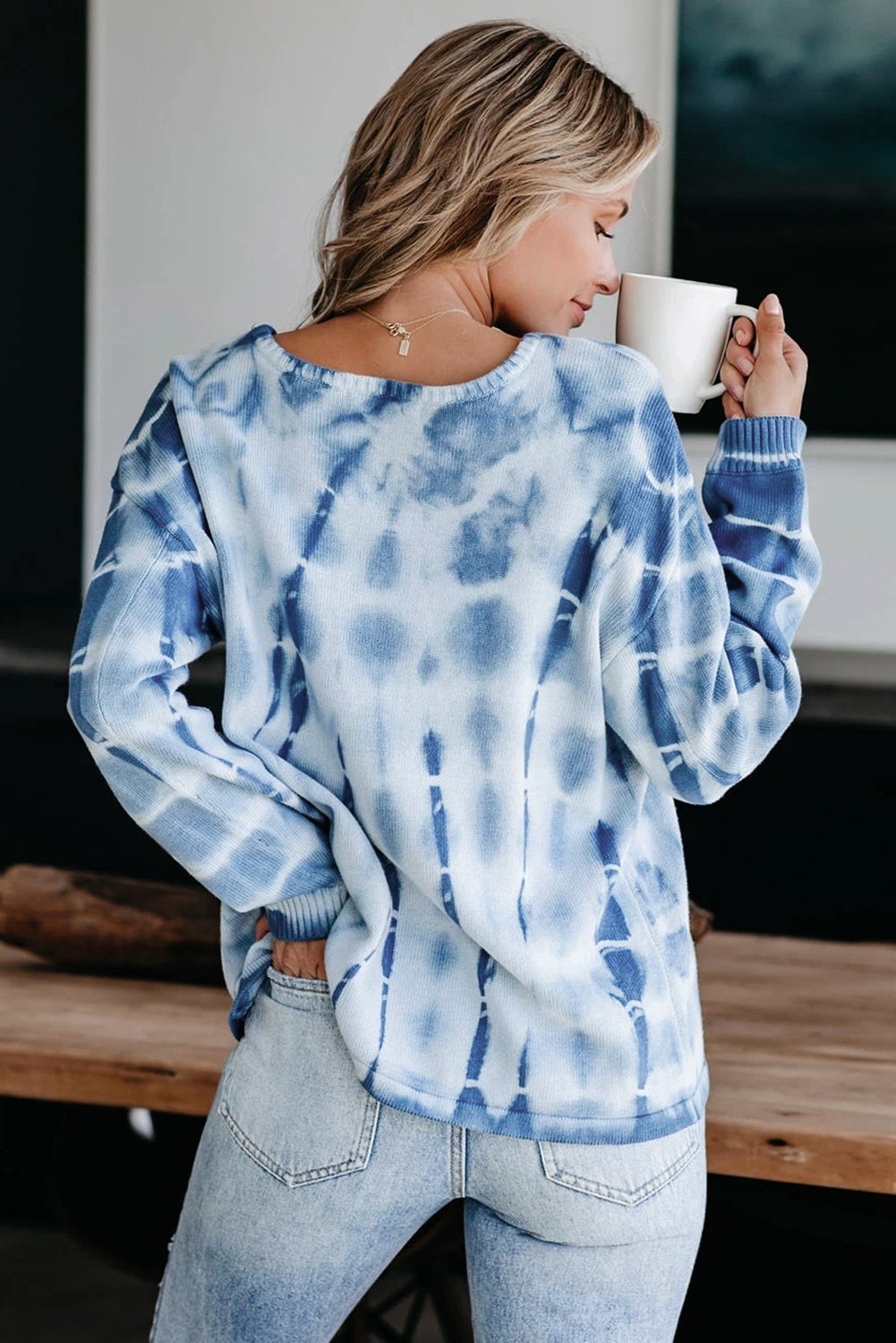 A cozy tie-dye print knit sweater featuring a relaxed fit, perfect for all body types, showcasing vibrant colors and chunky knit fabric.