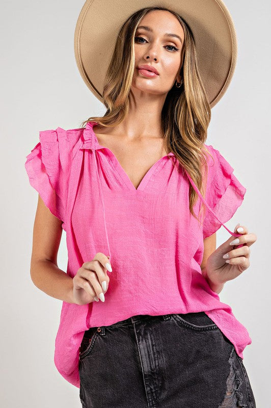 A stylish tiered ruffle sleeve short sleeve blouse with a neck tie, showcasing elegant ruffle details and a soft fabric blend.