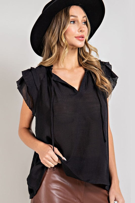 A stylish tiered ruffle sleeve short sleeve blouse with a neck tie, showcasing elegant ruffle details and a soft fabric blend.