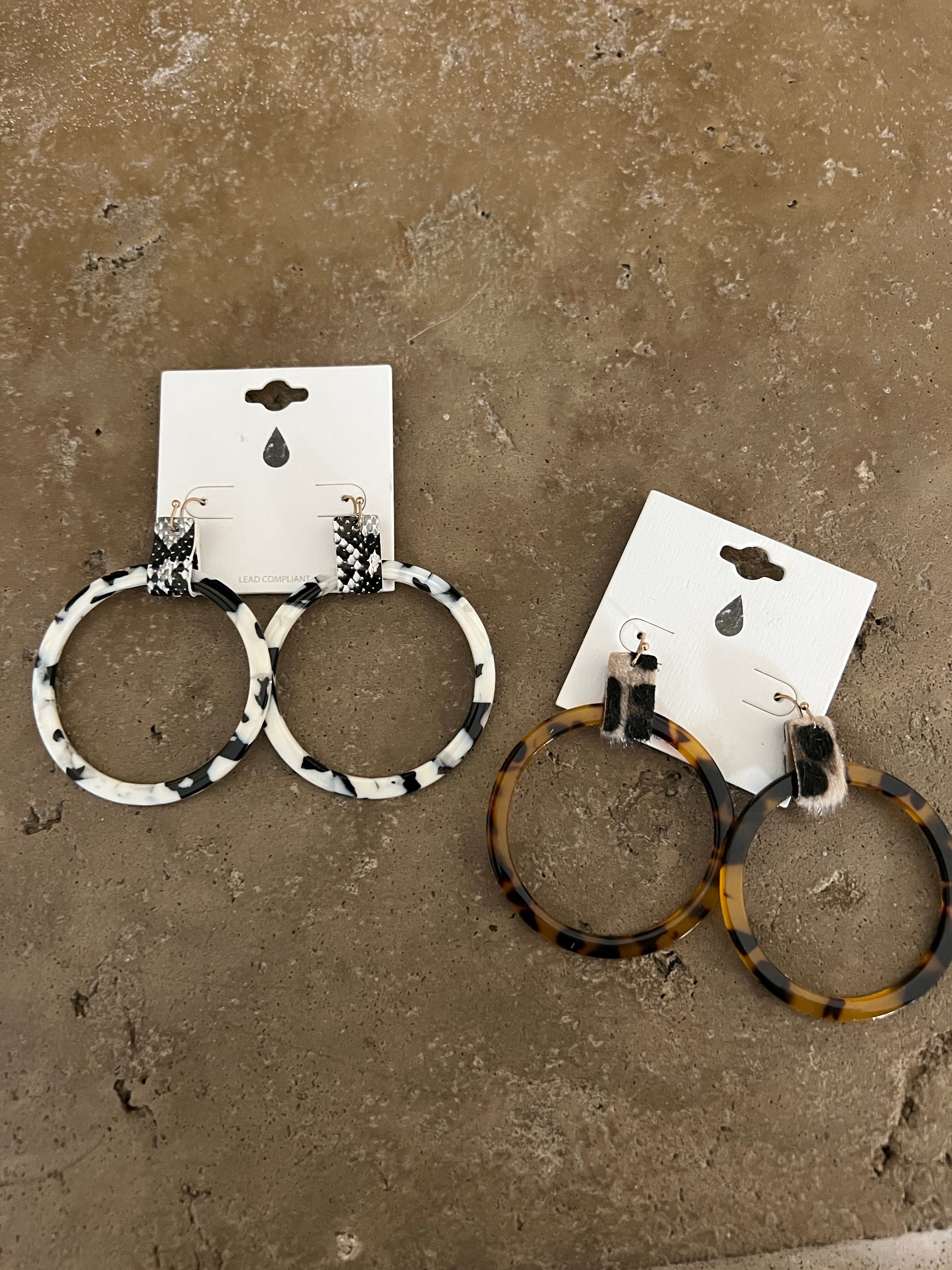 Lightweight tortoise shell hoop earrings featuring a stylish animal print faux leather accent, perfect for any outfit.