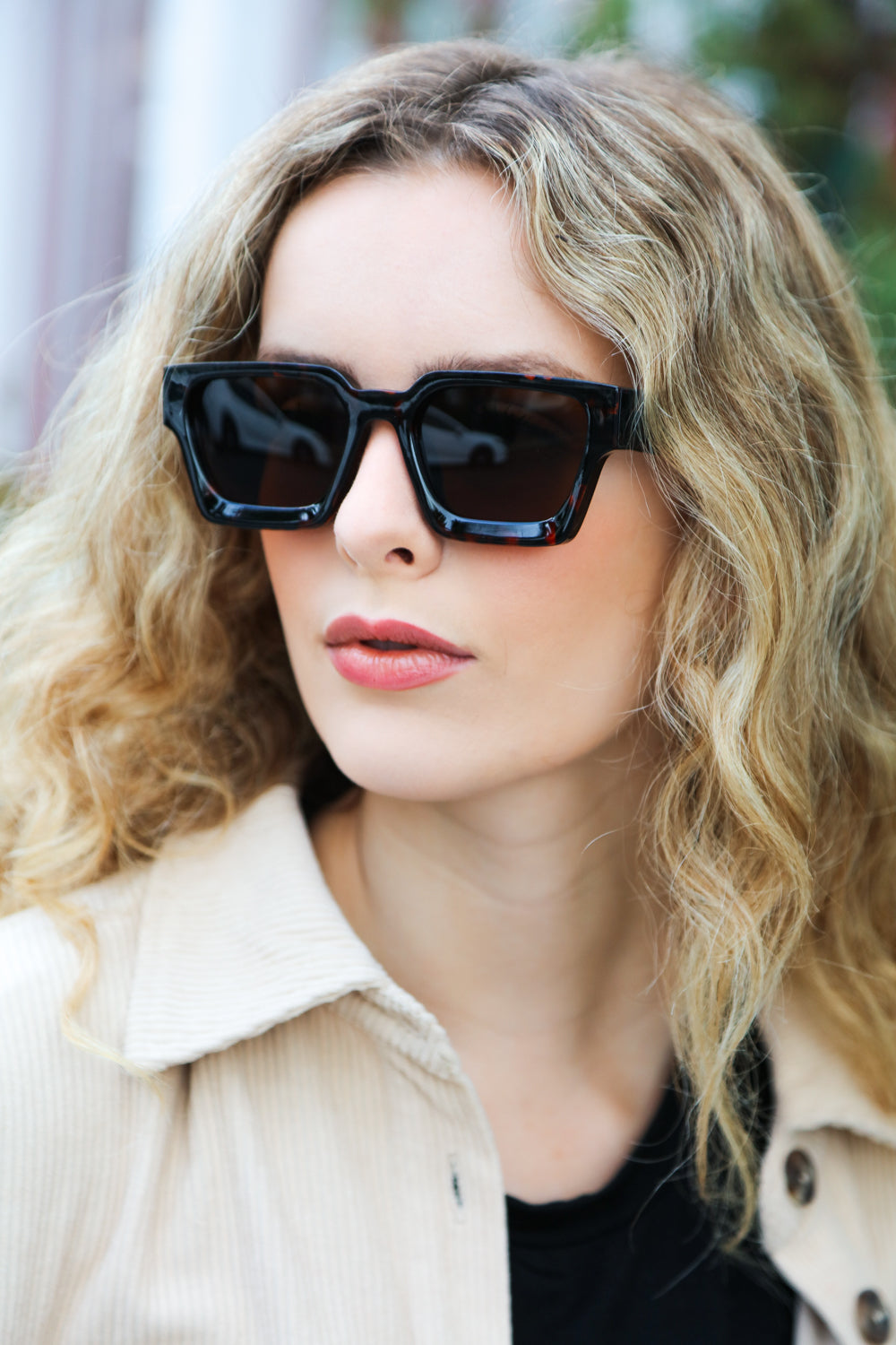 A pair of stylish tortoise shell thick frame rectangle sunglasses with brown tinted lenses, featuring a keyhole nose bridge.