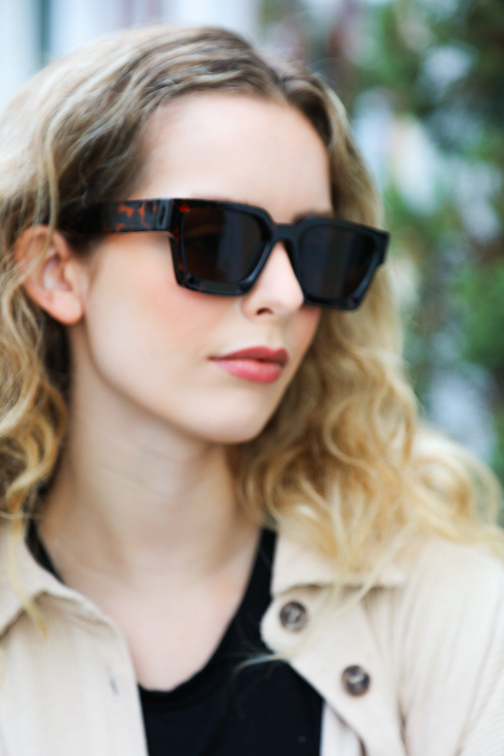 A pair of stylish tortoise shell thick frame rectangle sunglasses with brown tinted lenses, featuring a keyhole nose bridge.