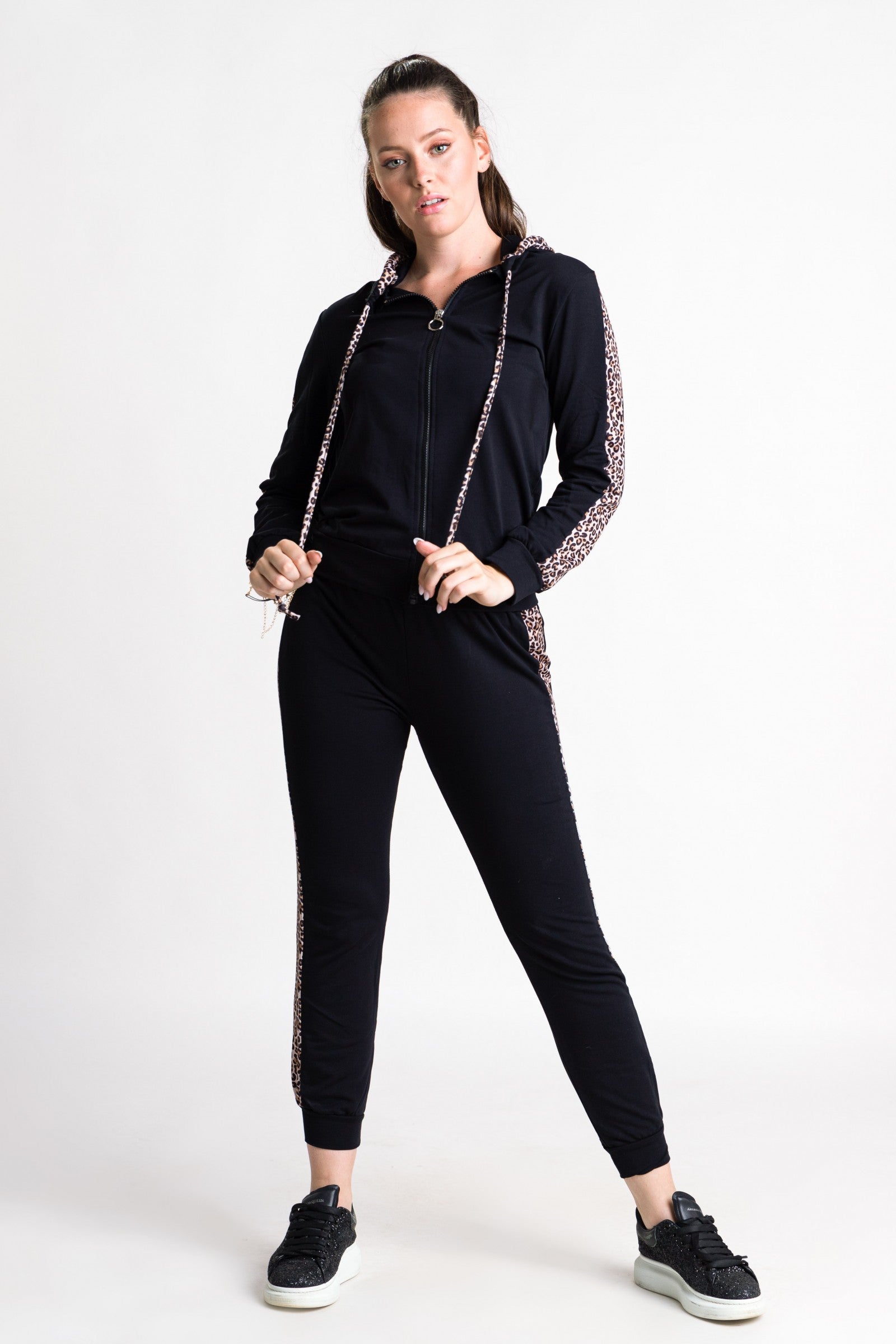 Black tracksuit set featuring a stylish tiger print, including a hooded top and long pants with elastic waist and ankle.