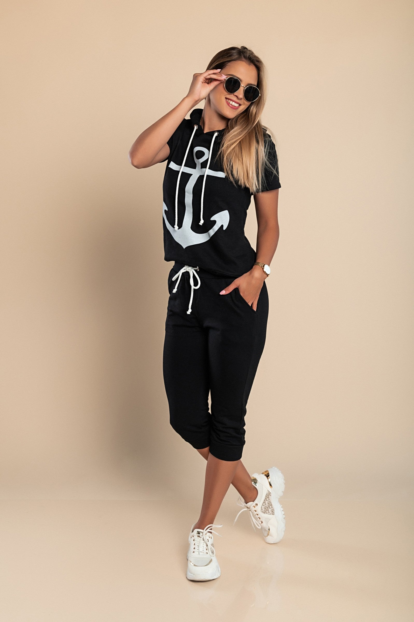 Aisla tracksuit featuring a stylish anchor print on a black T-shirt and matching 3/4 length pants with front pockets.