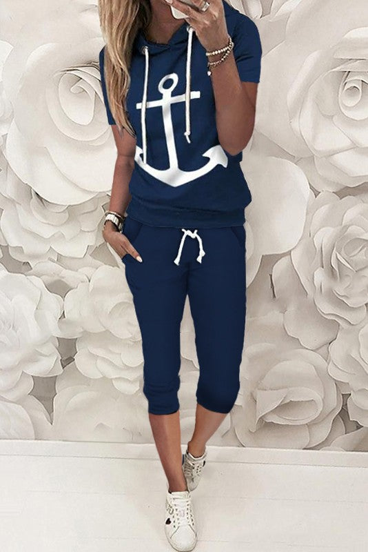 Aisla dark blue tracksuit featuring a stylish anchor print on the T-shirt and 3/4 length pants with front pockets, made from high-quality cotton.