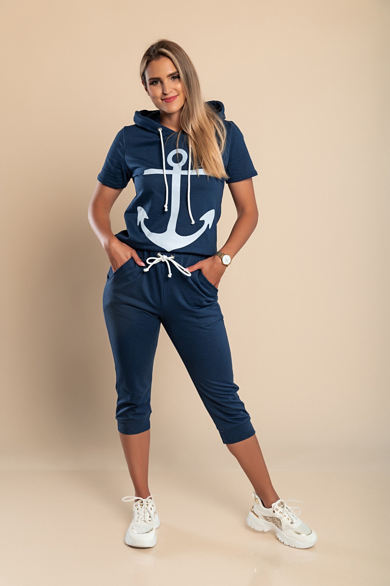 Aisla dark blue tracksuit featuring a stylish anchor print, consisting of a short-sleeve T-shirt and 3/4 length pants with front pockets.