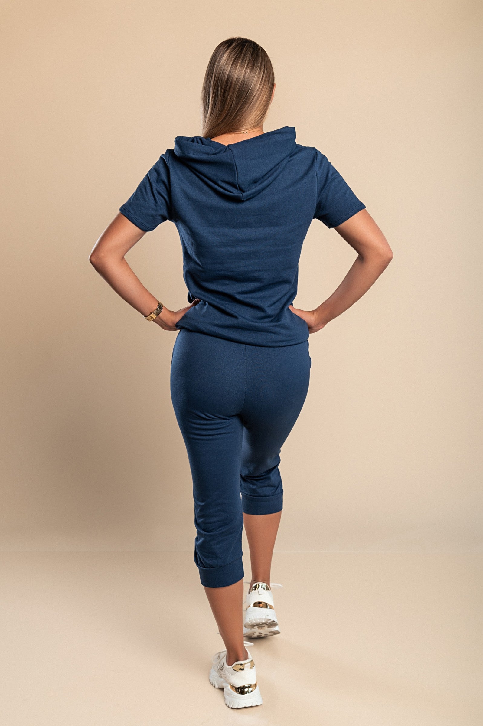 Aisla dark blue tracksuit featuring a stylish anchor print, consisting of a short-sleeve T-shirt and 3/4 length pants with front pockets.