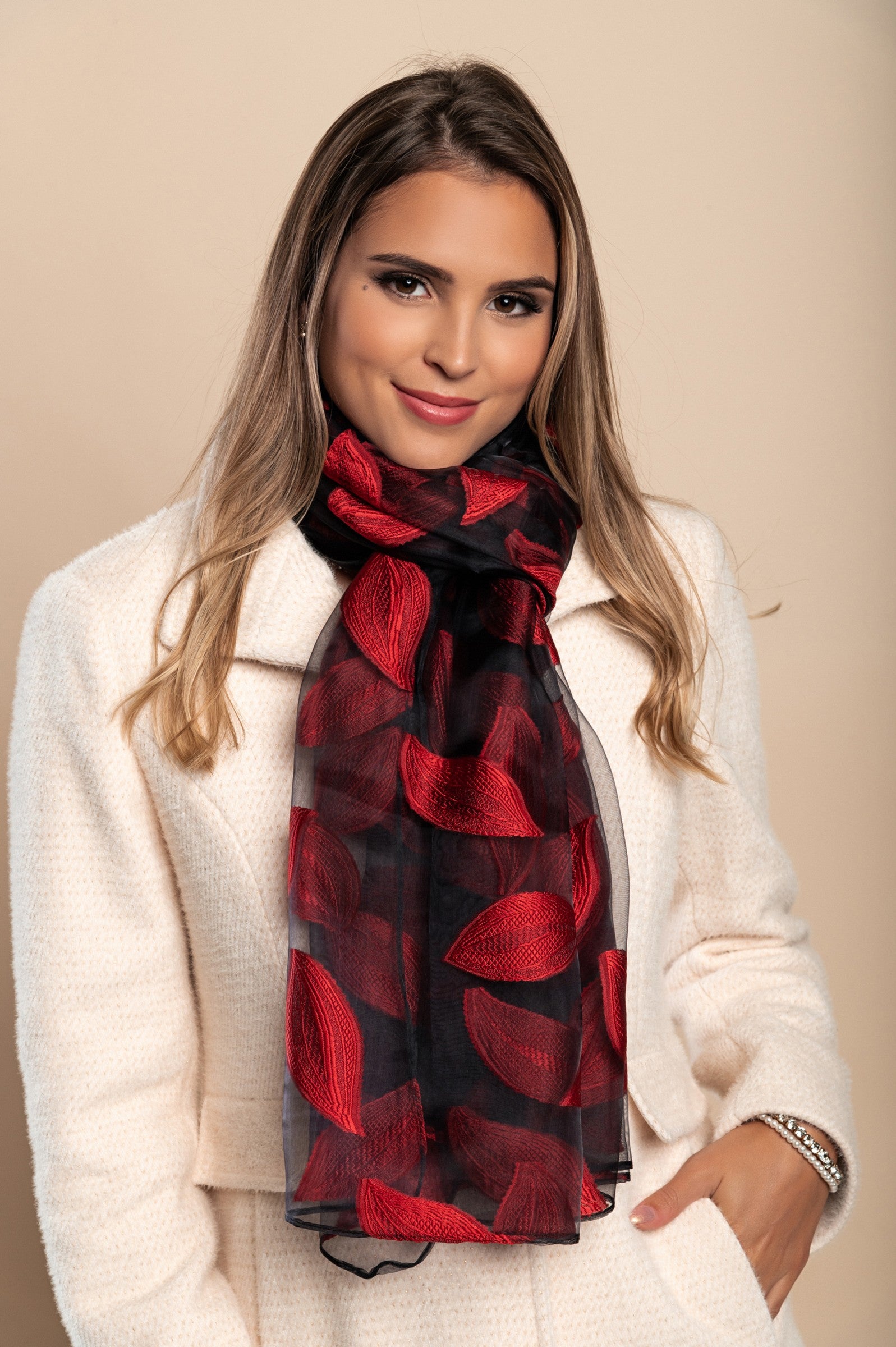 Elegant red transparent scarf with intricate contrast color embroidery, made from a soft viscose and silk blend.