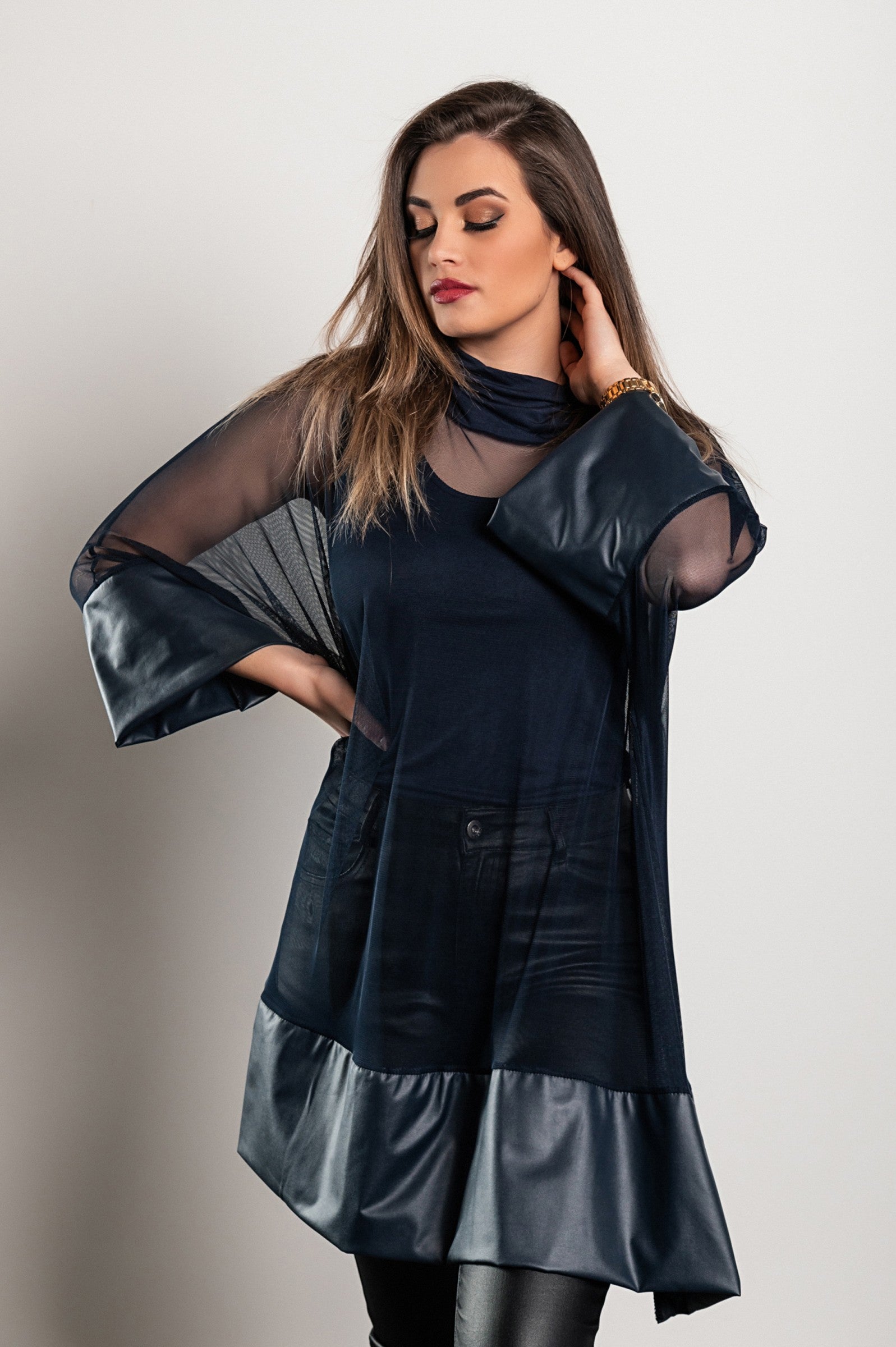 A stylish blue transparent tunic featuring artificial leather accents, high neckline, and faux fur sleeves, perfect for various occasions.