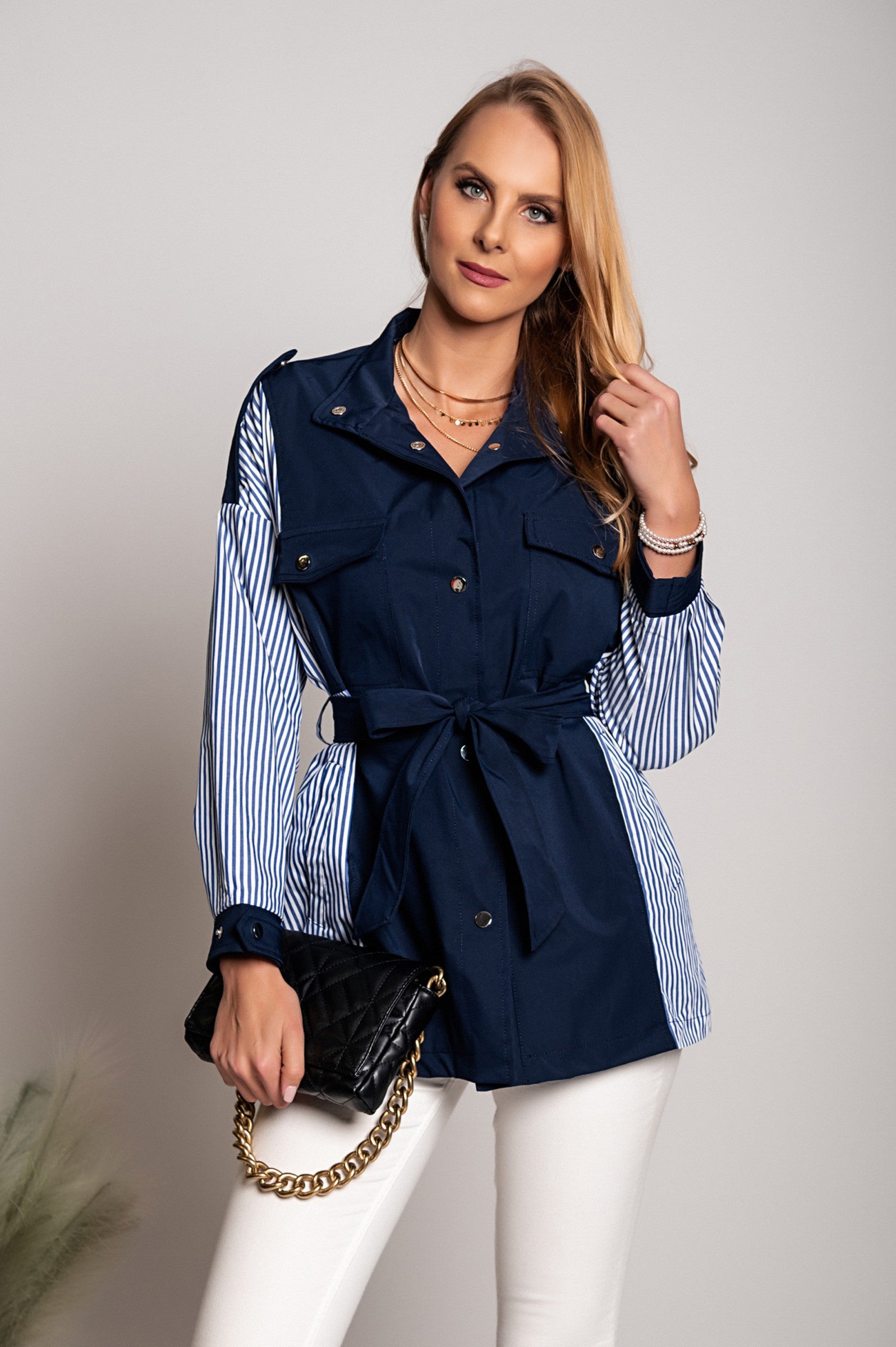 Blue Trench Coat Jalapa with high neck, long sleeves, and decorative shoulder straps, featuring a stylish two-tone design.