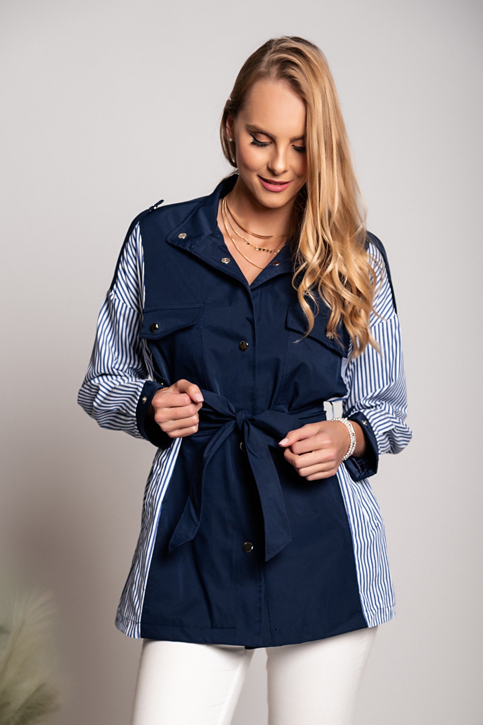 Blue Trench Coat Jalapa with high neck, long sleeves, and decorative shoulder straps, featuring a stylish two-tone design.