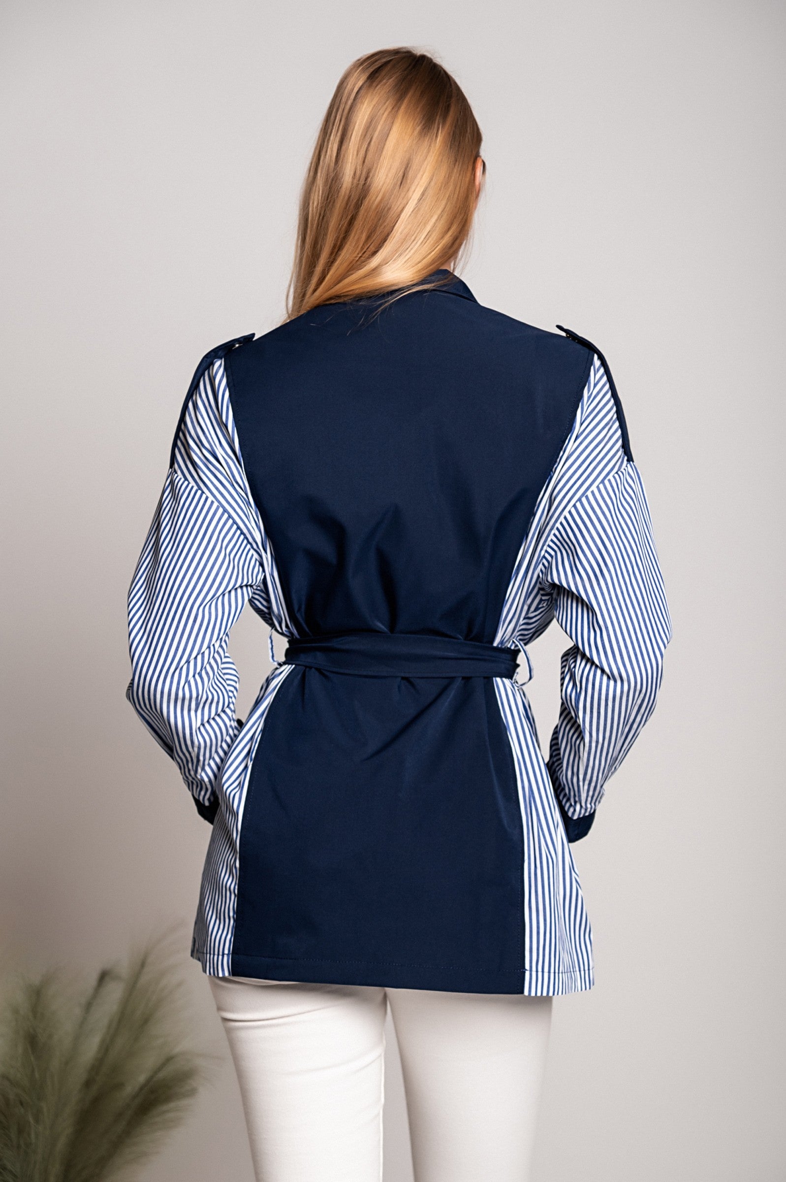 Blue Trench Coat Jalapa with high neck, long sleeves, and decorative shoulder straps, featuring a stylish two-tone design.