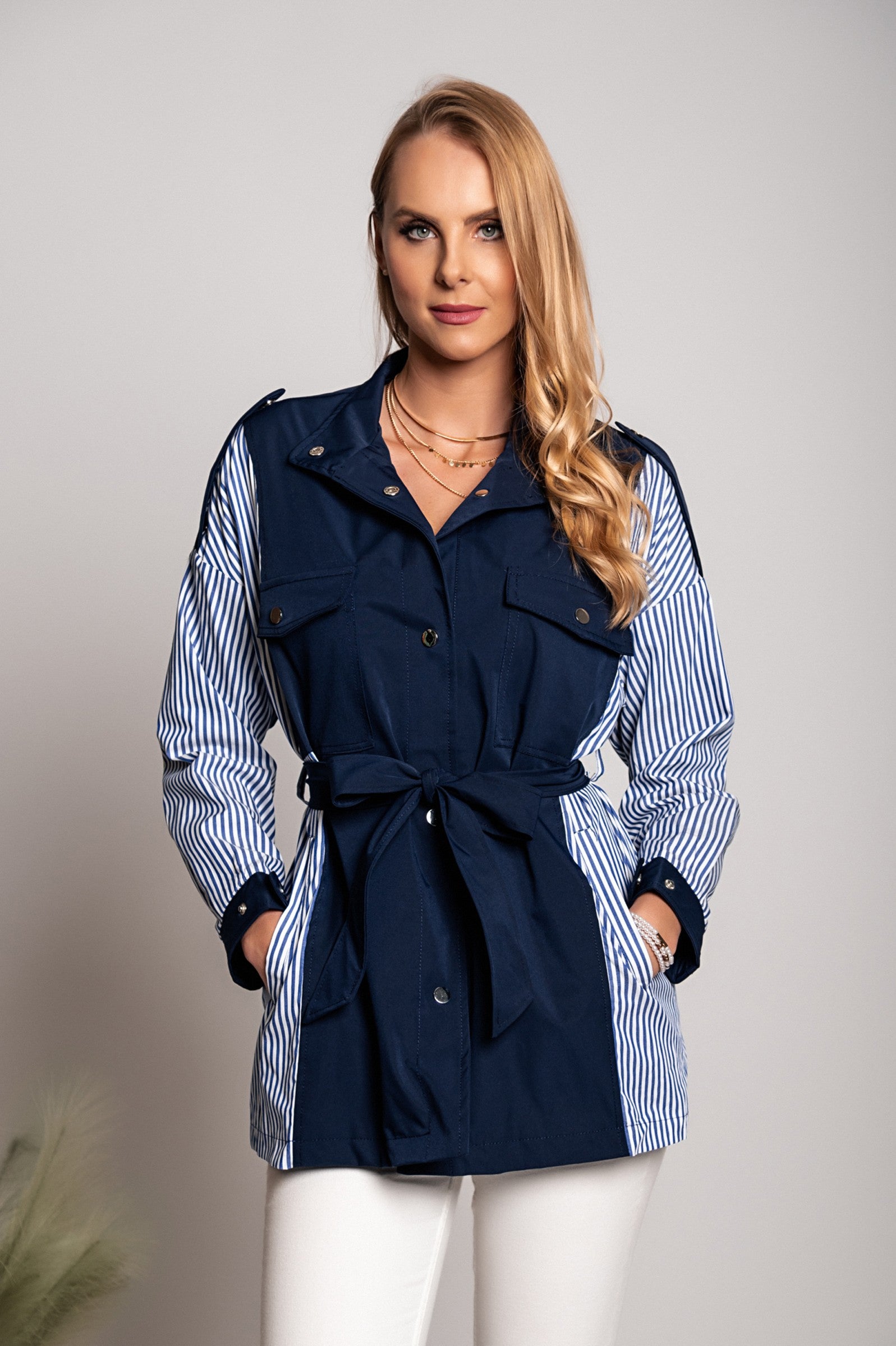 Blue Trench Coat Jalapa with high neck, long sleeves, and decorative shoulder straps, featuring a stylish two-tone design.