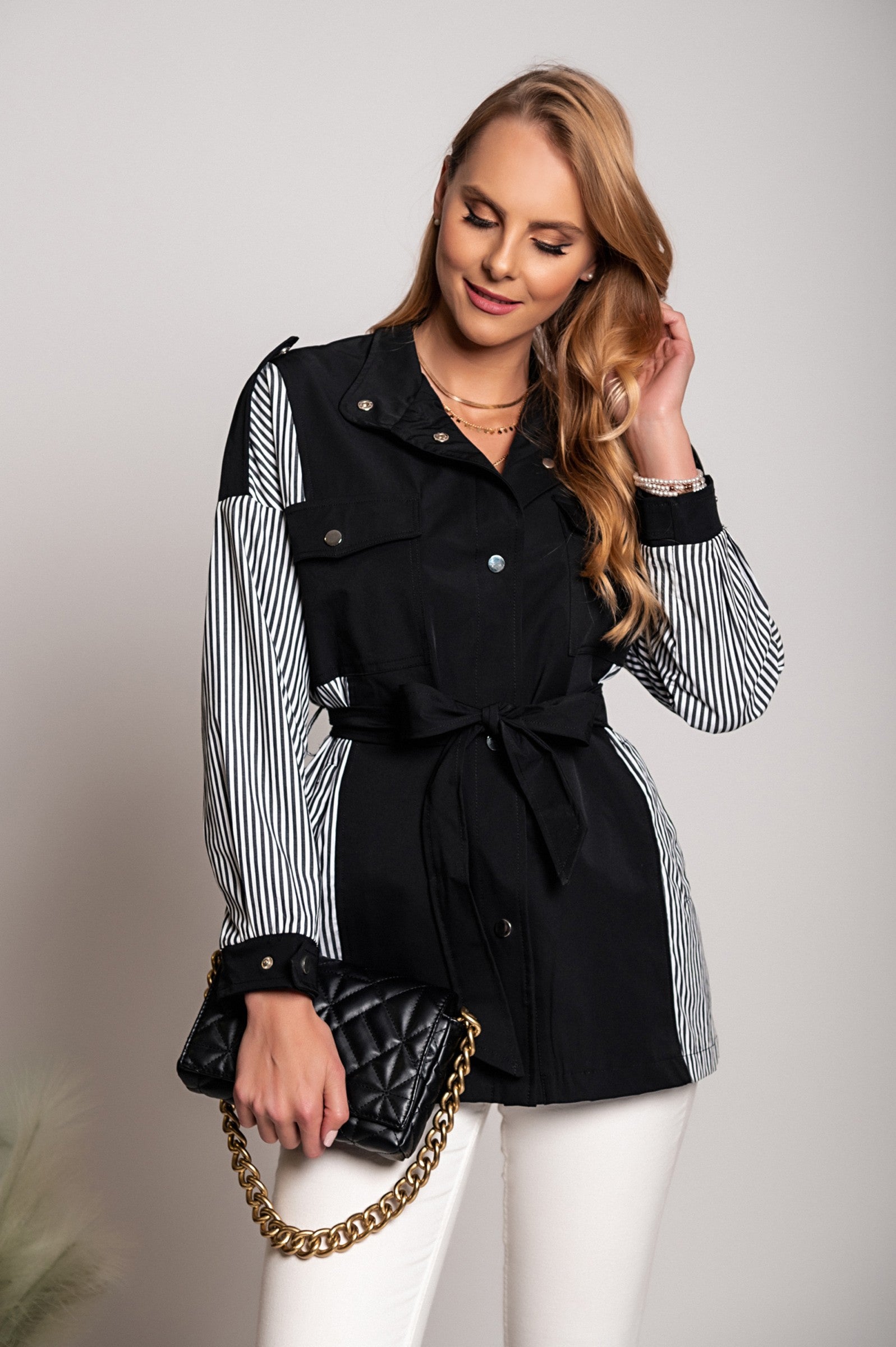 Black Trench Coat Xalapa featuring a high collar, decorative shoulder straps, and front button closure, made from quality polyester fabric.