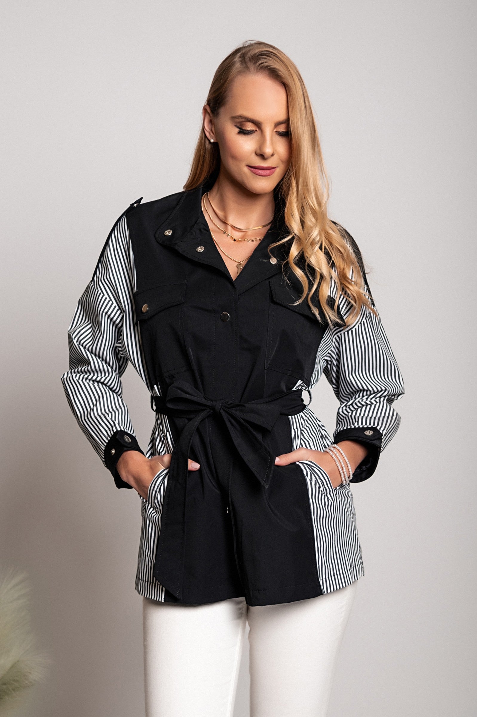 Black Trench Coat Xalapa featuring a high collar, decorative shoulder straps, and front button closure, made from quality polyester fabric.