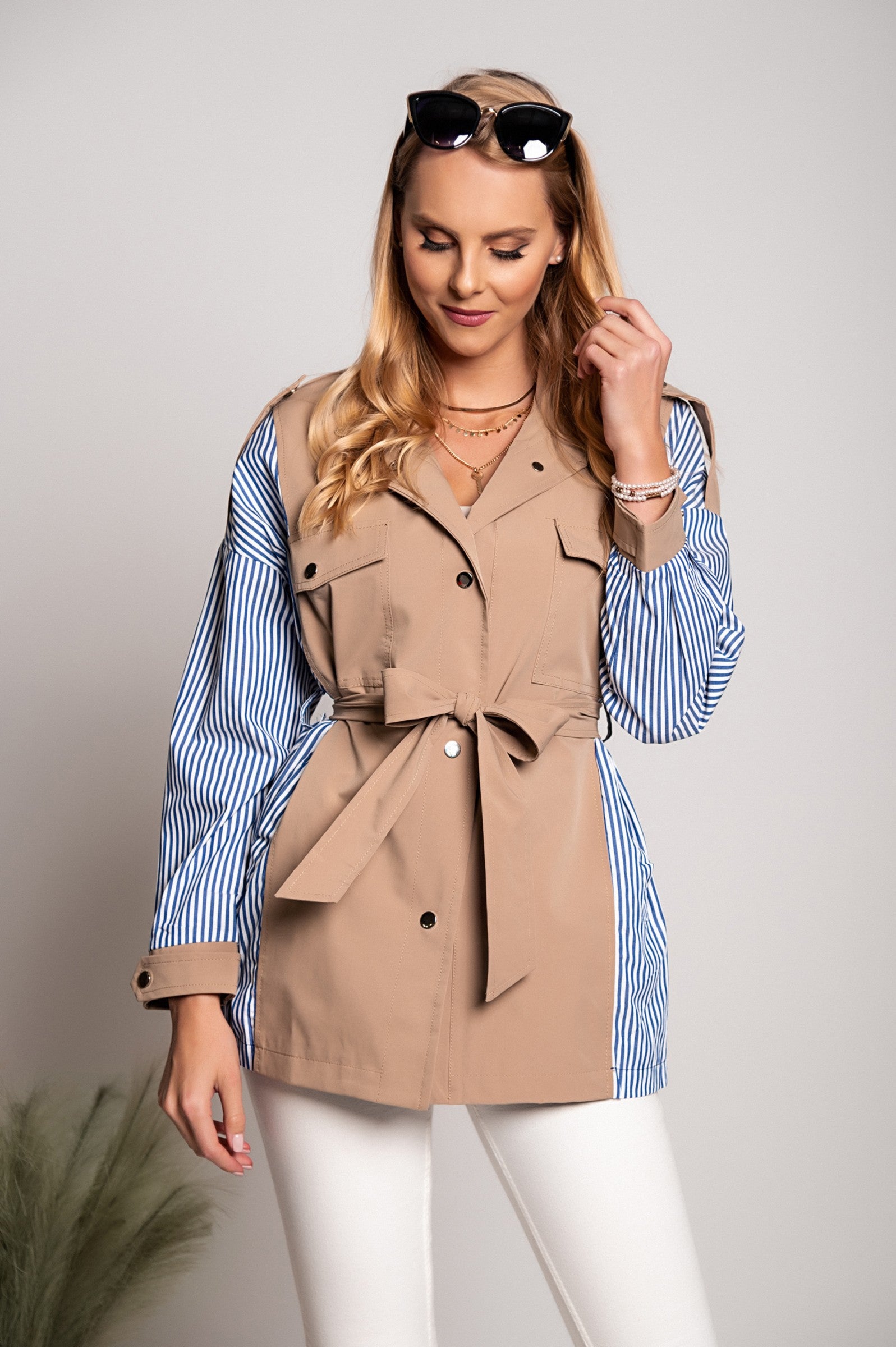 Khaki Trenchcoat Xalapa featuring a high collar, decorative shoulder straps, and front button closure.