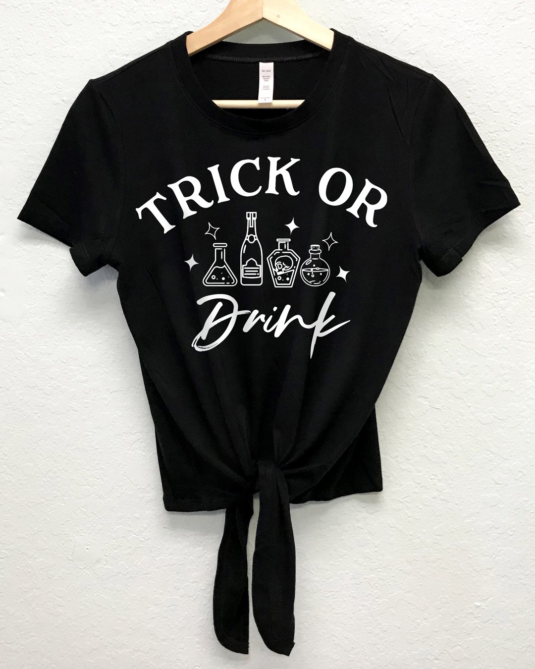 Trick or Drink Halloween Crop Top Shirt with front tie, featuring a playful design perfect for Halloween celebrations.