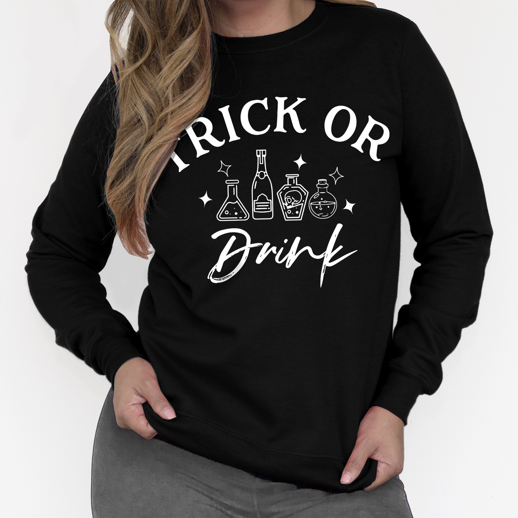 A cozy women's sweatshirt featuring the phrase 'Trick or Drink' in a festive Halloween design, perfect for parties and casual wear.