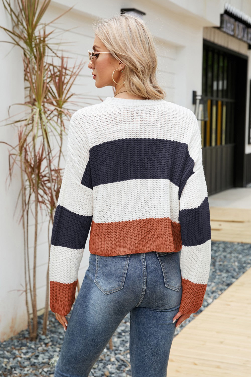 Tricolor color block round neck sweater with dropped shoulders, featuring a chic striped pattern, perfect for casual wear.