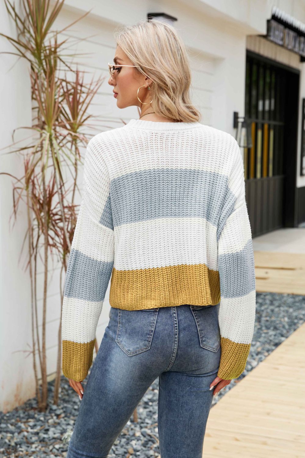 Tricolor color block round neck sweater with dropped shoulders, featuring a chic striped pattern, perfect for casual wear.