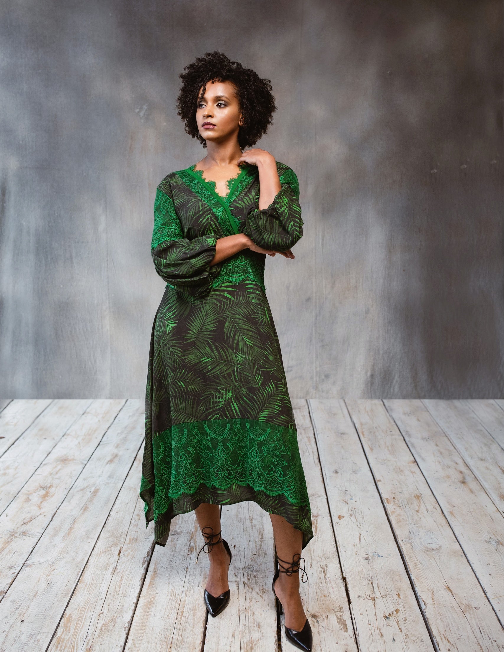 A stylish Tropical Print Dress featuring lace accents, statement sleeves, and an asymmetric hem, perfect for various occasions.