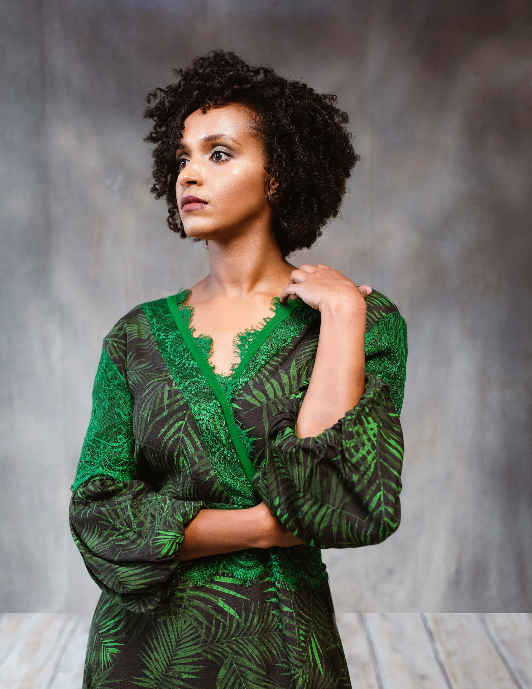 A stylish Tropical Print Dress featuring lace accents, statement sleeves, and an asymmetric hem, perfect for various occasions.