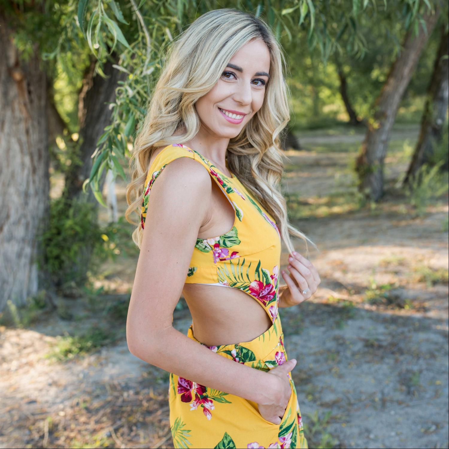 A stylish Tropical Tie Back Jumpsuit featuring a vibrant floral pattern, deep V back, and wide leg design, perfect for summer outings.